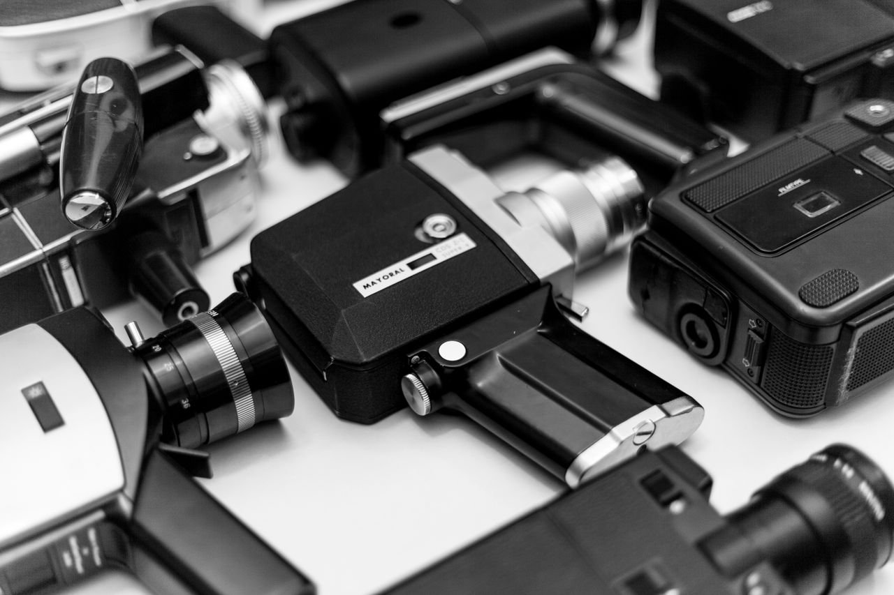 A collection of vintage cameras in black and white, showcasing retro photographic equipment.