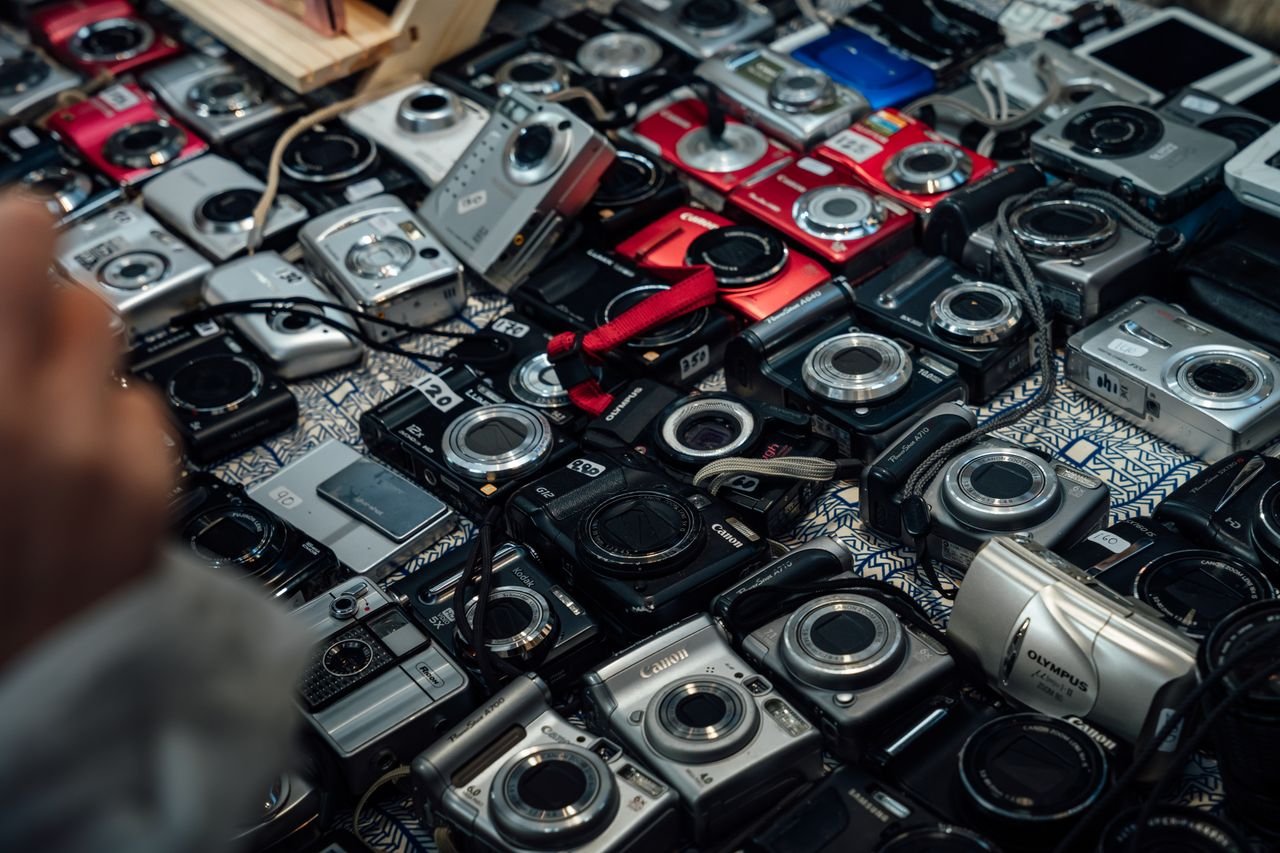 Services Assorted vintage cameras arranged on a patterned table in London, England.